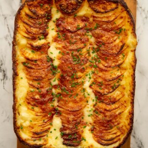overhead shot of mashed potato au gratin fresh out the oven garnished with chives