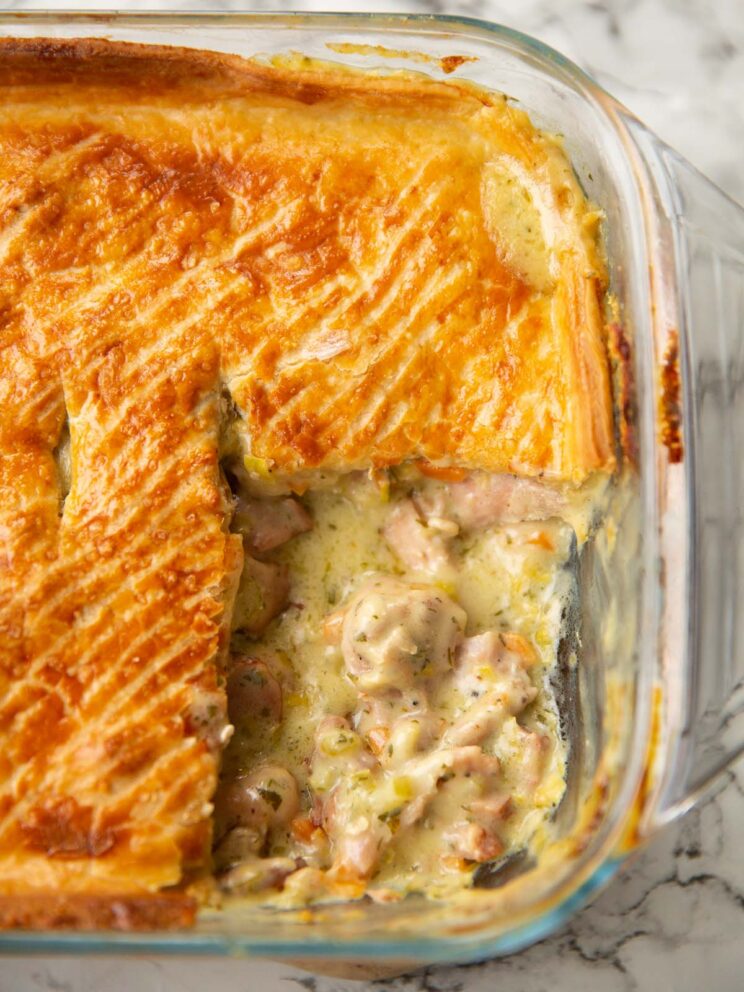 chicken ham pie fresh out the oven with portion taken out