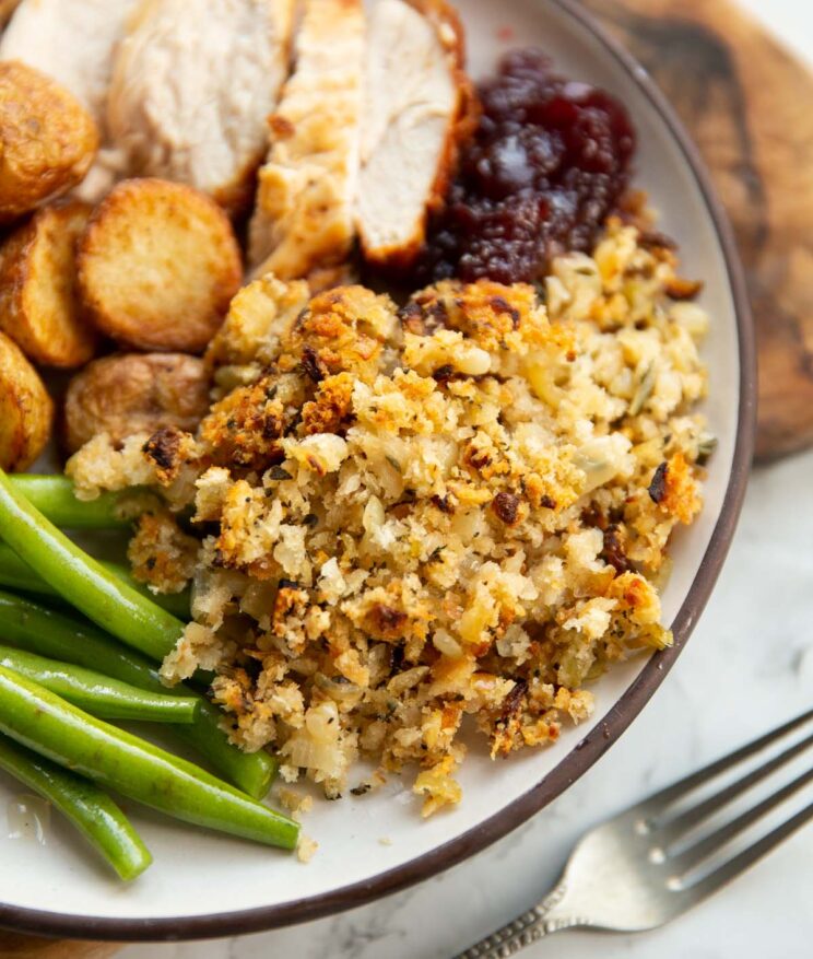close up shot of homemade sage and onion stuffing on small white plate