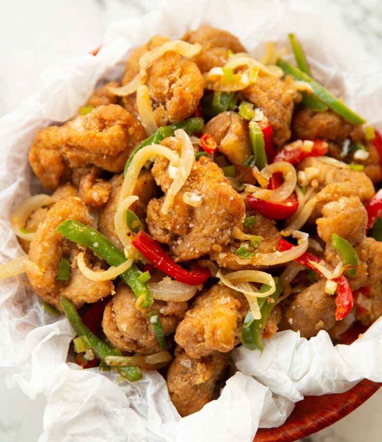 salt and chilli chicken in small bowl on scrunched up baking paper