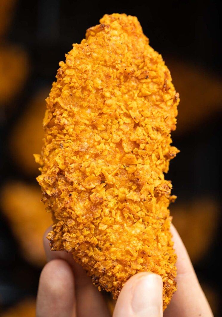 close up overhead shot of hand holding doritos chicken tender