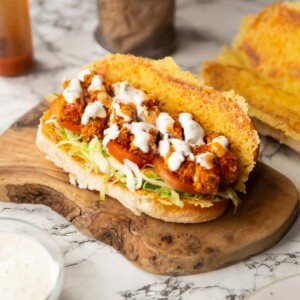 chicken tenders sandwich on wooden board showing filling