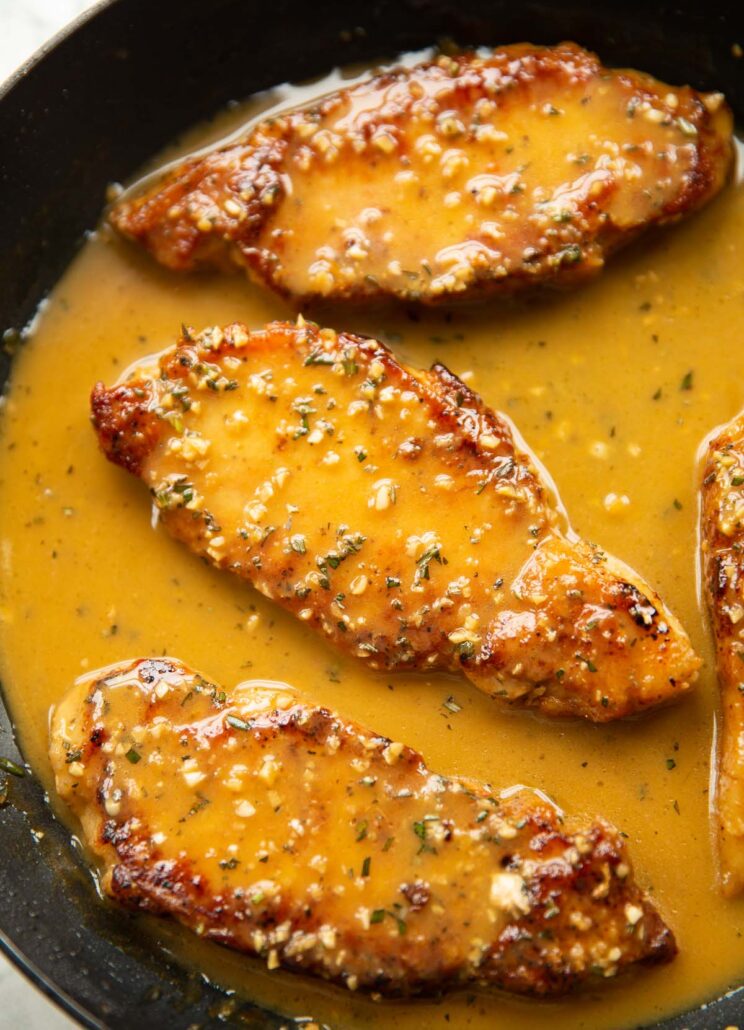 3 garlic rosemary butter pork chops in large pan