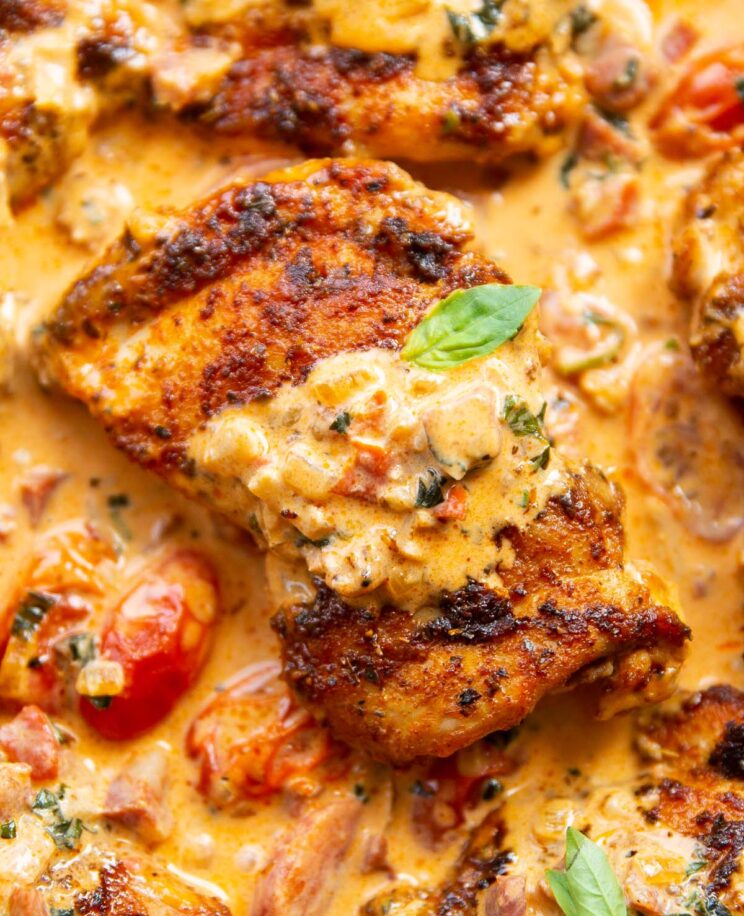 close up overhead shot of chicken thigh in creamy chorizo sauce in pan
