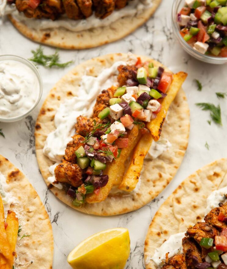 overhead shot of unfolded chicken souvlaki on marble backdrop