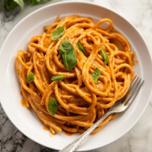 cottage cheese pasta served in white bowl with fresh basil