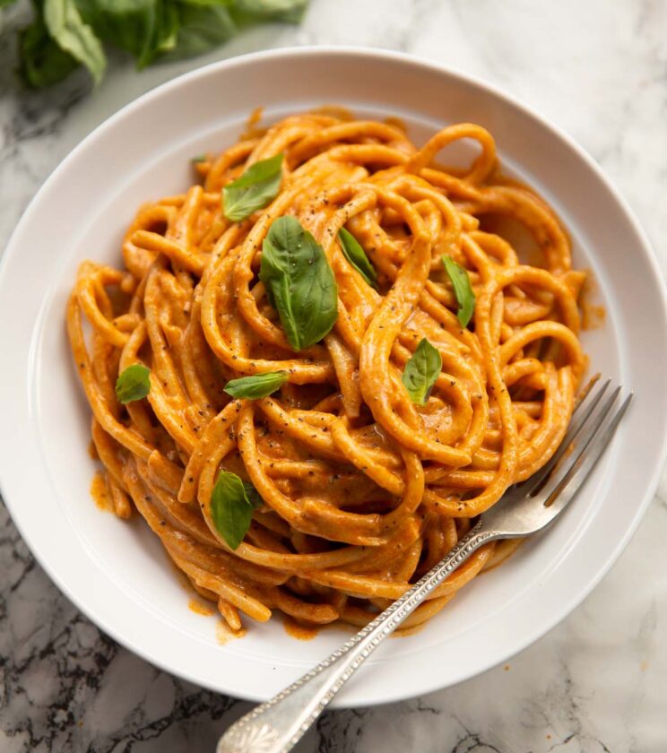 cottage cheese pasta served in white bowl with fresh basil
