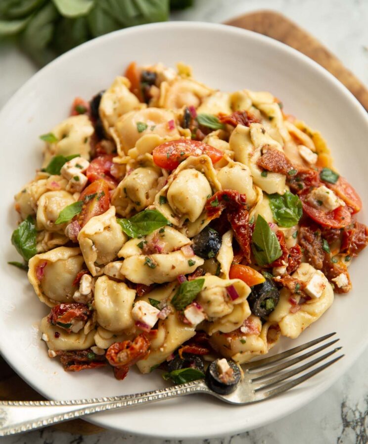 sun dried tomato pasta salad served on small white plate with silver fork