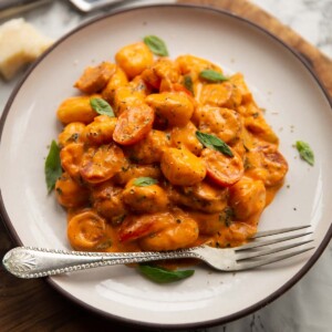 creamy gnocchi chorizo on small white plate with silver fork