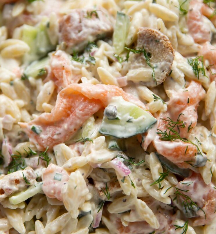 close up shot of smoked salmon pasta salad in very large bowl