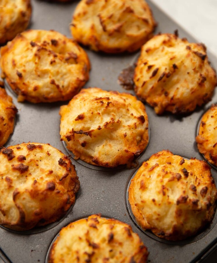 close up shot of mini cottage pies in muffin tin fresh out the oven