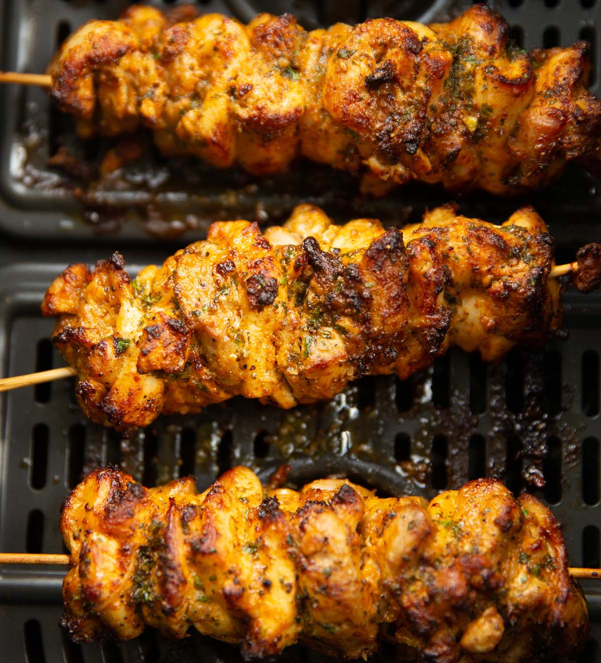 close up shot of 3 lemon chicken skewers in air fryer