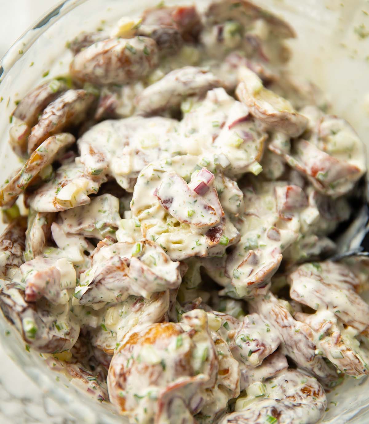 close up shot of crispy potato salad in large mixing bowl