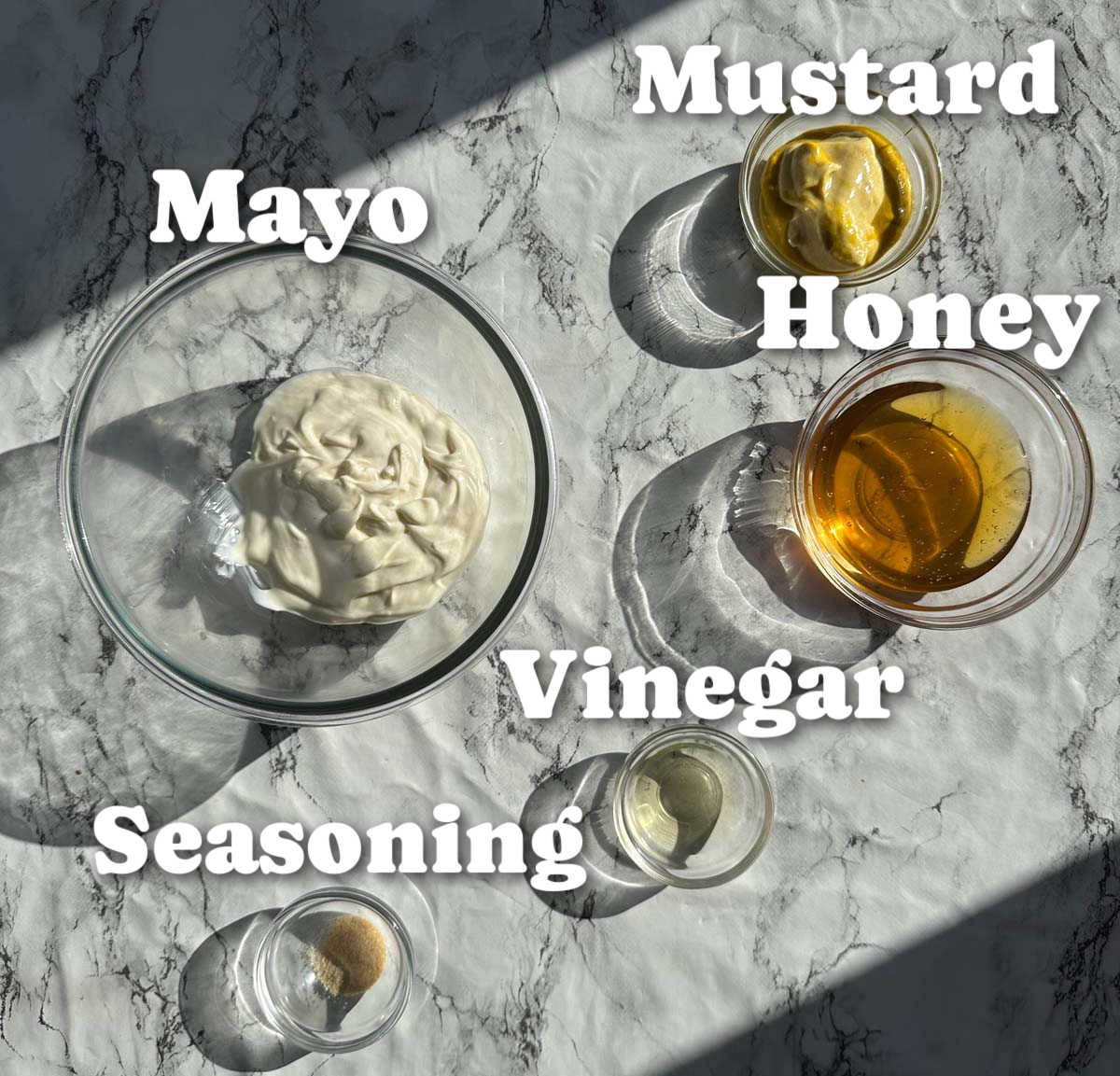 overhead shot of honey mustard sauce ingredients with text labels