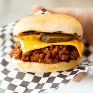 close up shot of hand holding sloppy joe