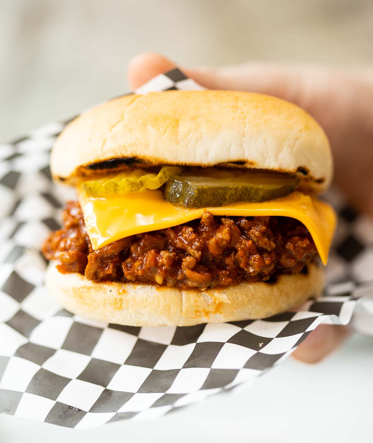 close up shot of hand holding sloppy joe