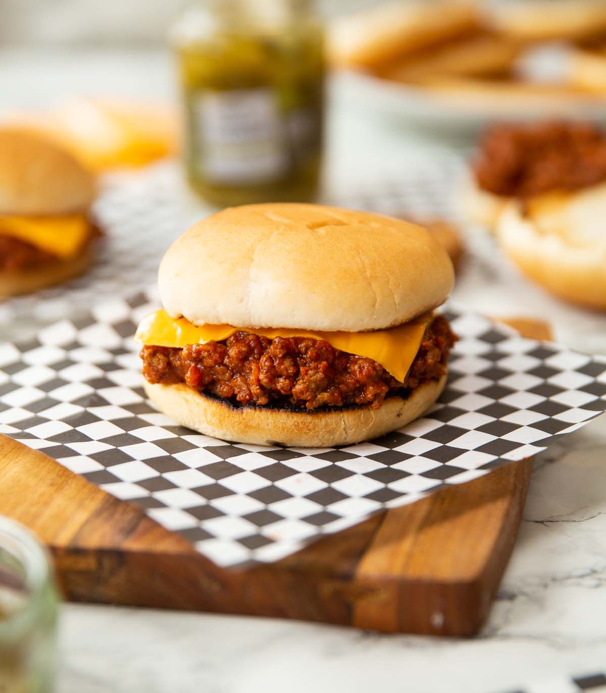 sloppy joe on wooden chopping board with cheese