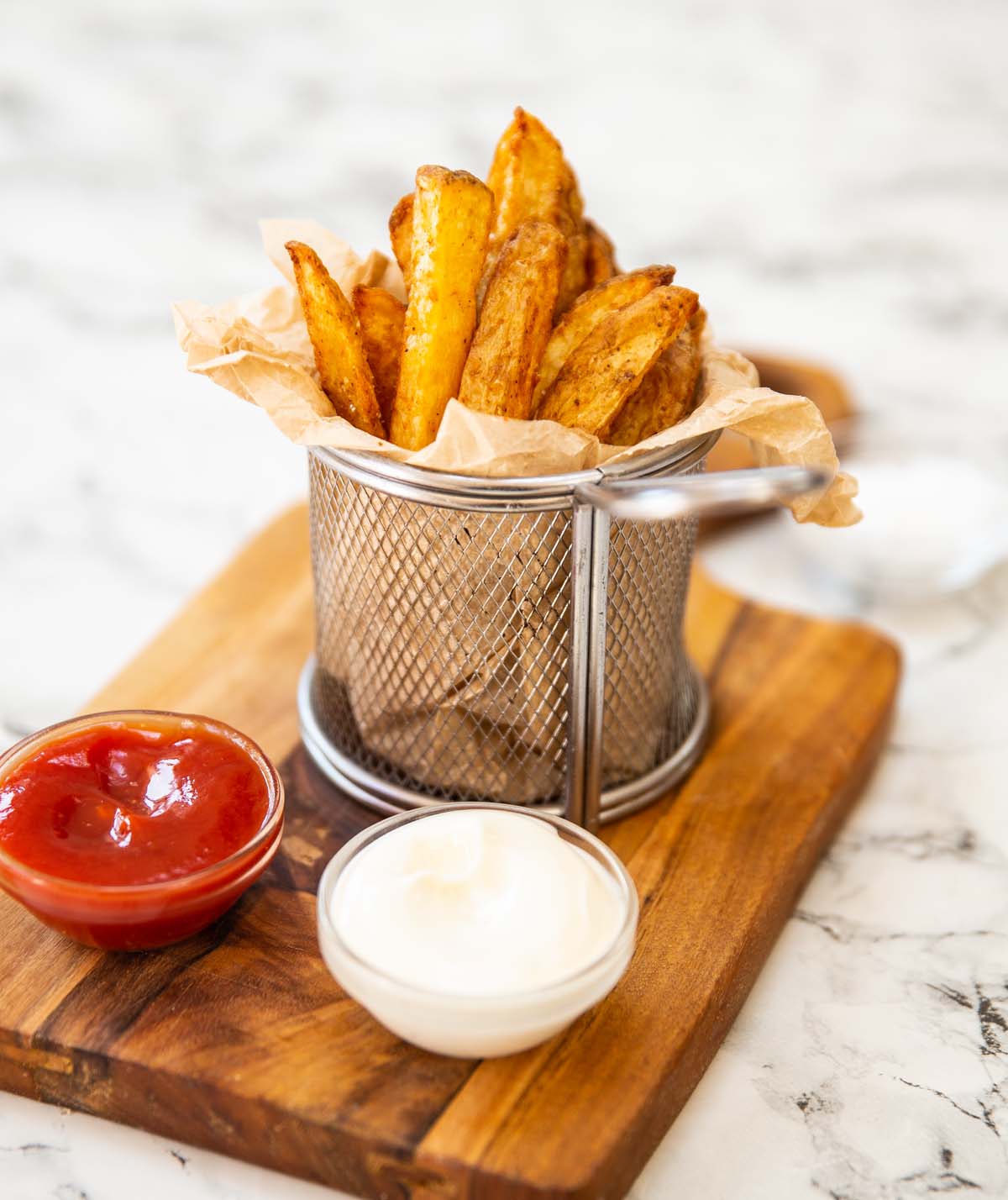 air fried chips in small basket with mayo and ketchup