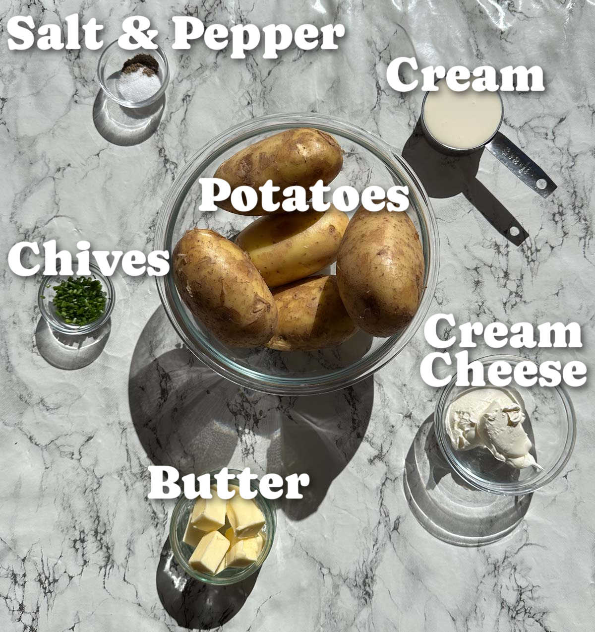 overhead shot of creamy mashed potatoes ingredients with text labels
