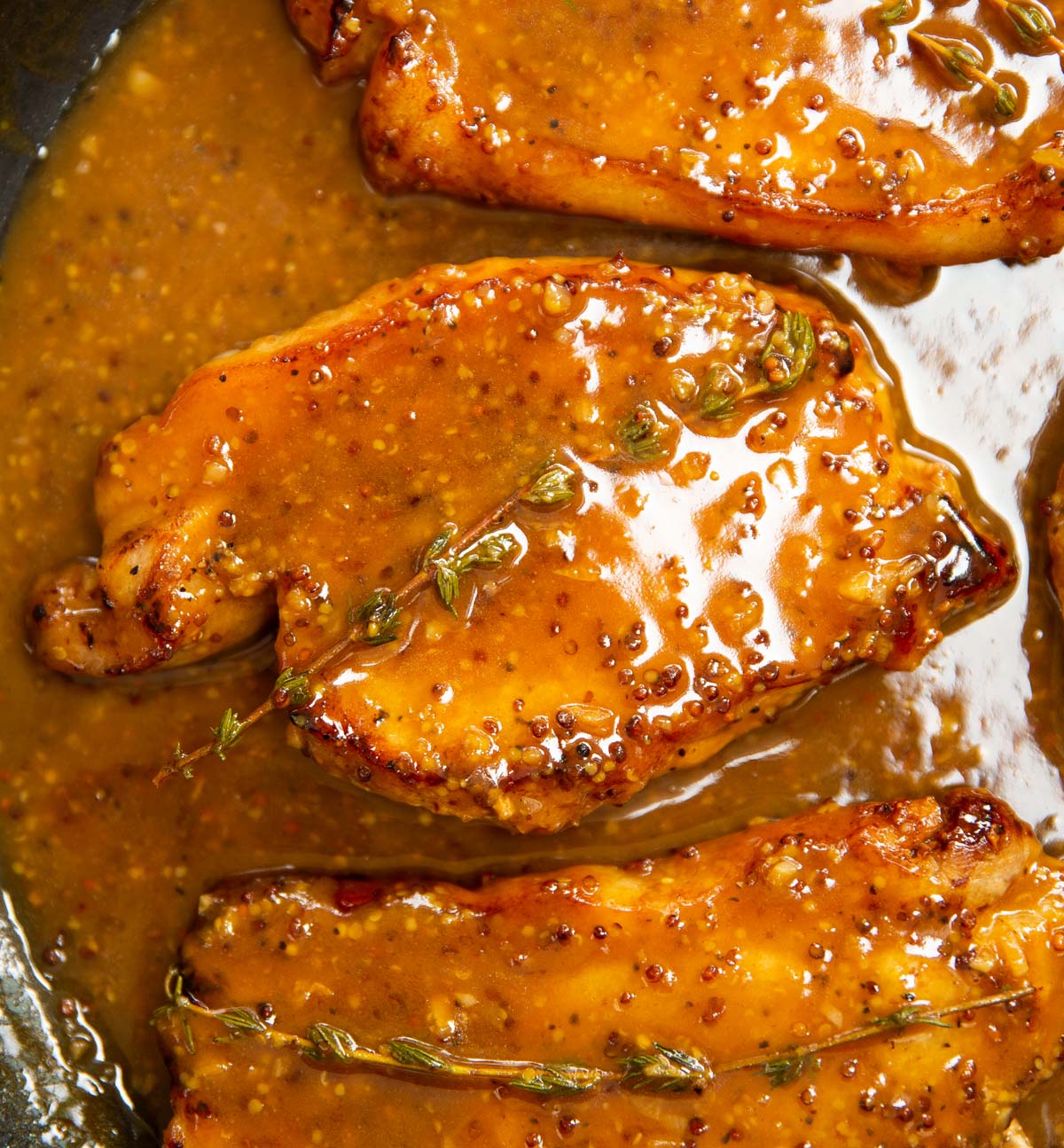 close up overhead shot of honey mustard pork in large pan
