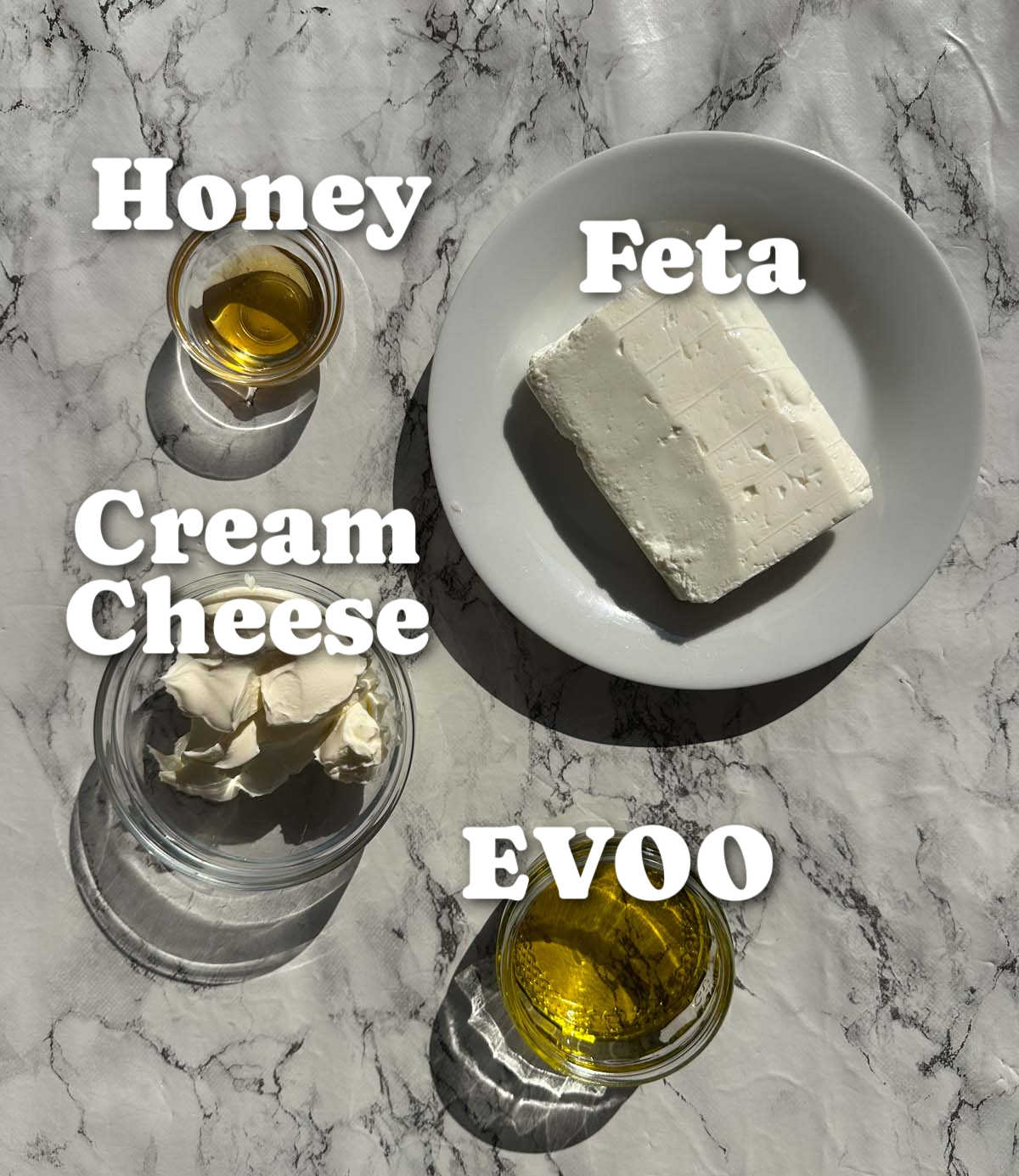 overhead shot of whipped feta ingredients with text labels
