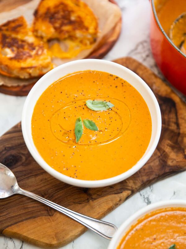 baked boursin soup in small white bowl with grilled cheese in background