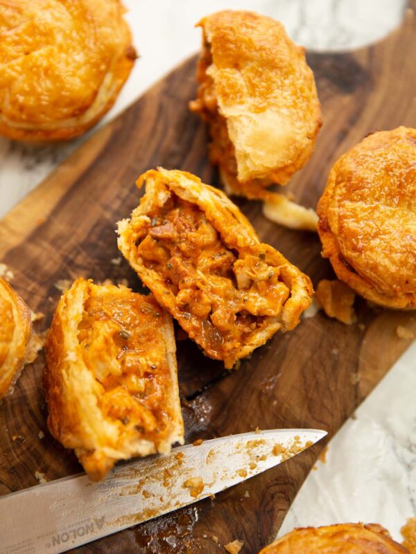 overhead close up shot of chicken and chorizo pies on chopping board