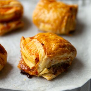 close up shot of sausage cheese onion puff on baking tray