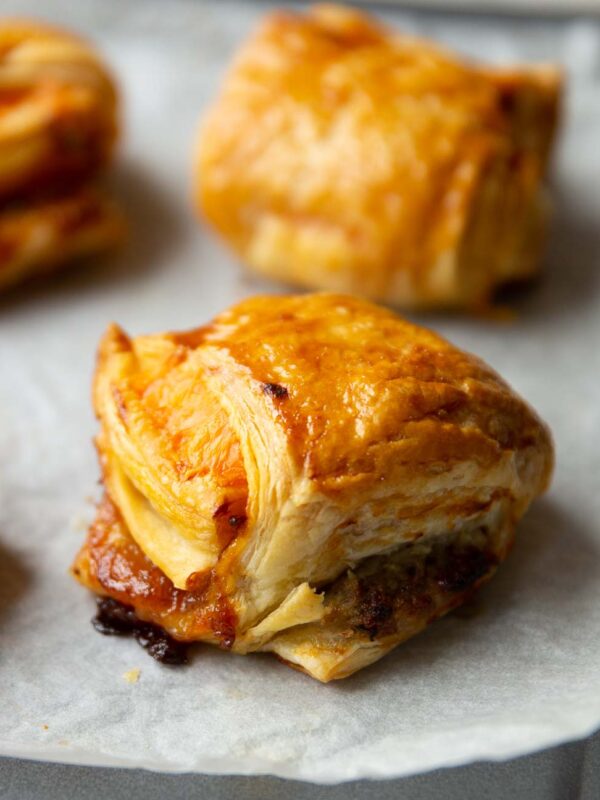 close up shot of sausage cheese onion puff on baking tray