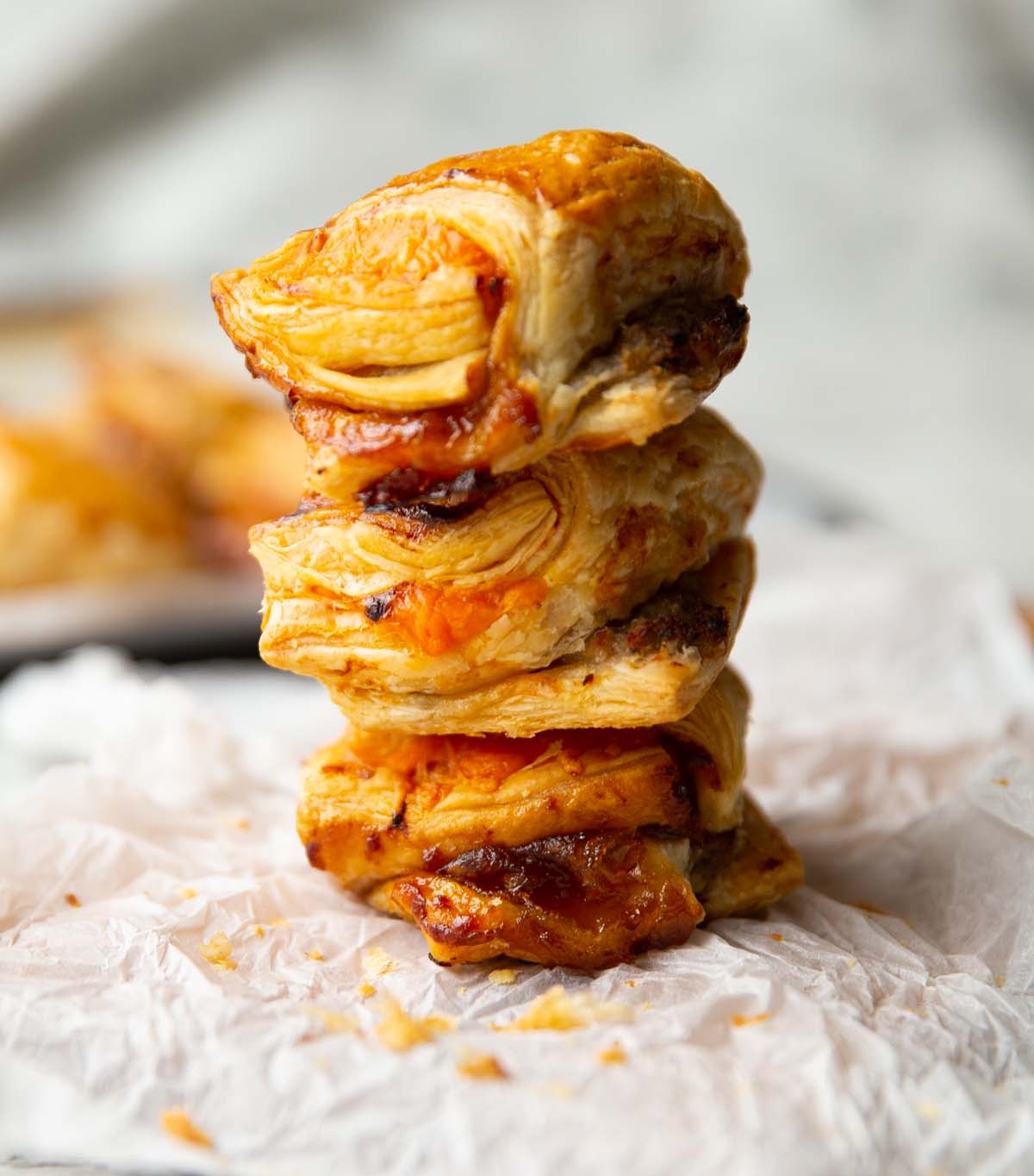 close up shot of 3 sausage puffs stacked on each other