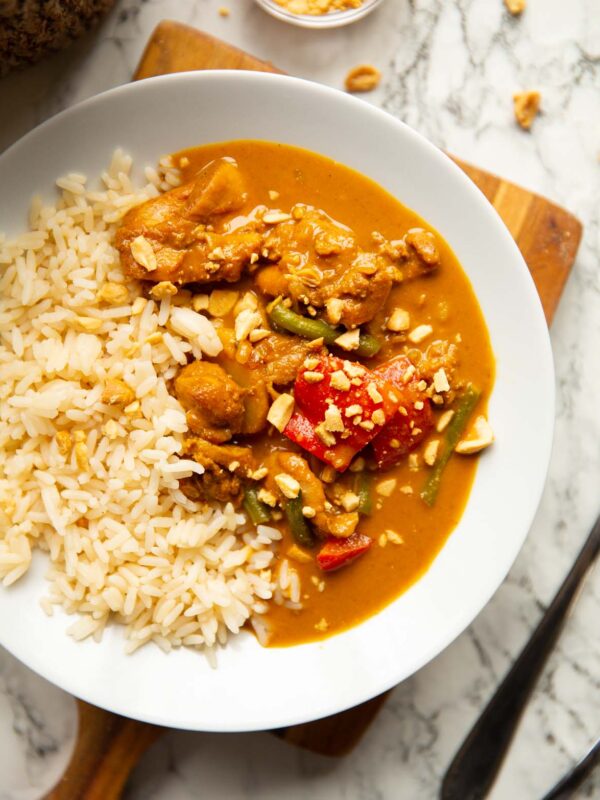 overhead shot of satay chicken in large white bowl with long grain rice