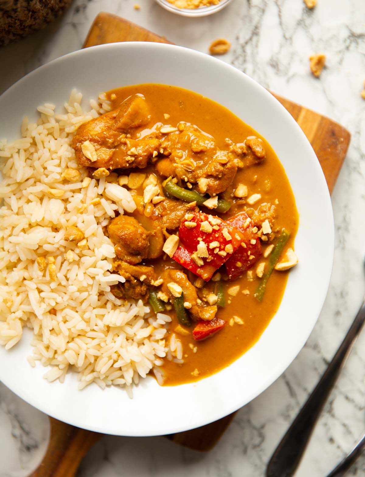 overhead shot of satay chicken in large white bowl with long grain rice