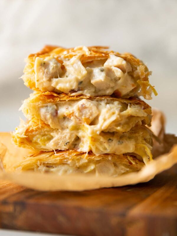 4 halved boursin bakes stacked on each other on wooden board