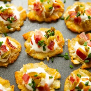 close up shot of smashed tater tots on large grey tray