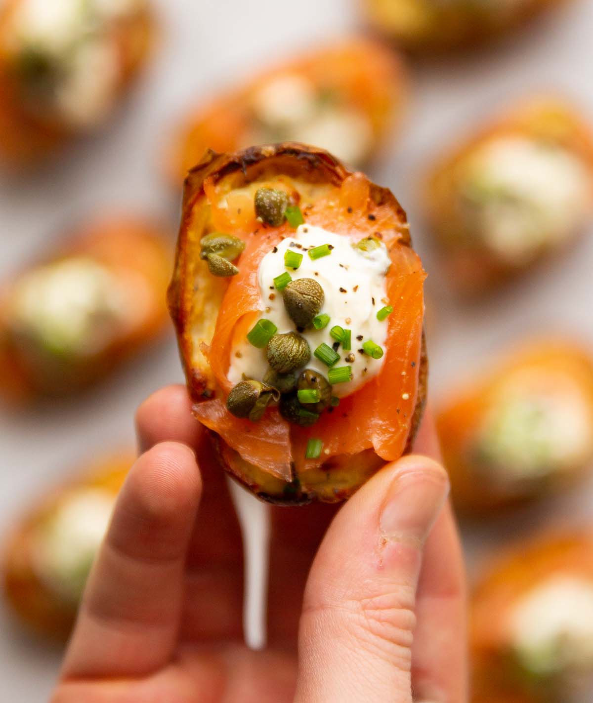 close up overhead shot of hand holding salmon potato