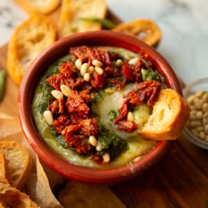 pesto baked brie with ciabatta dunking in