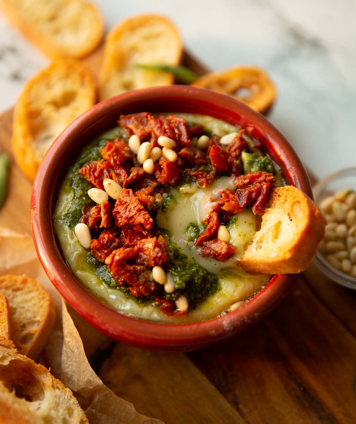 pesto baked brie with ciabatta dunking in