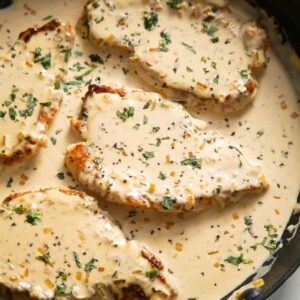 creamy mustard pork chops in large pan