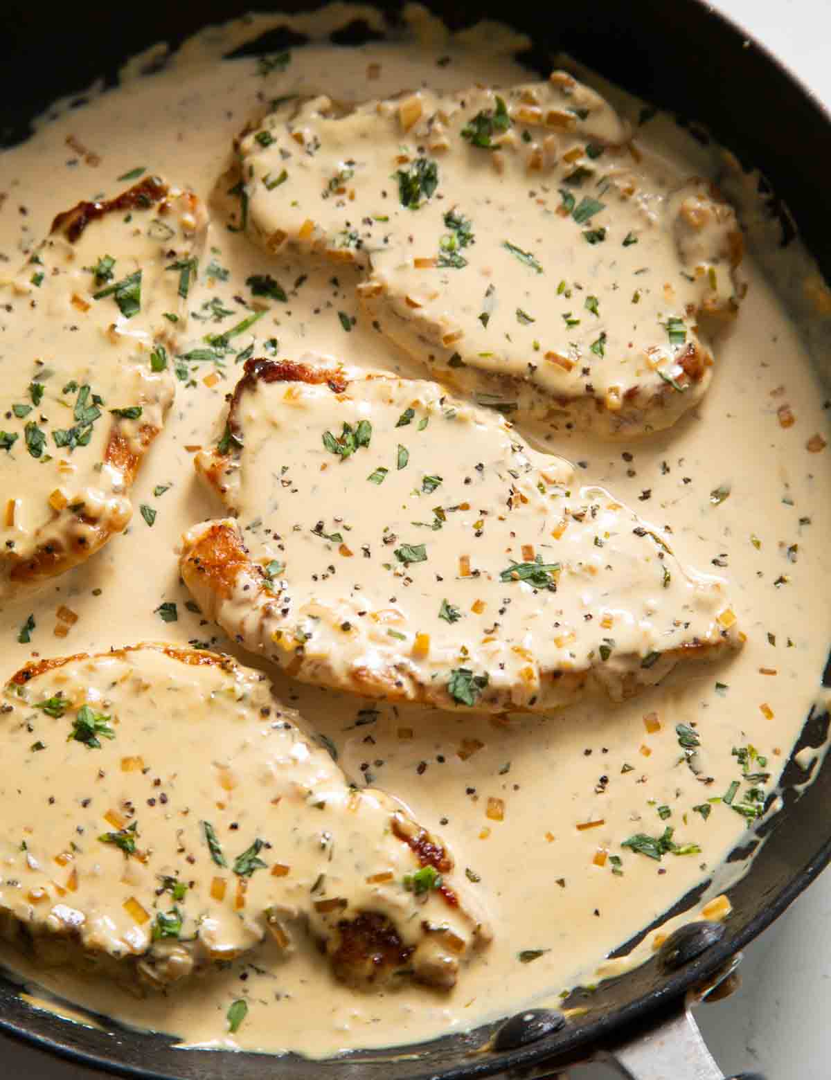 creamy mustard pork chops in large pan