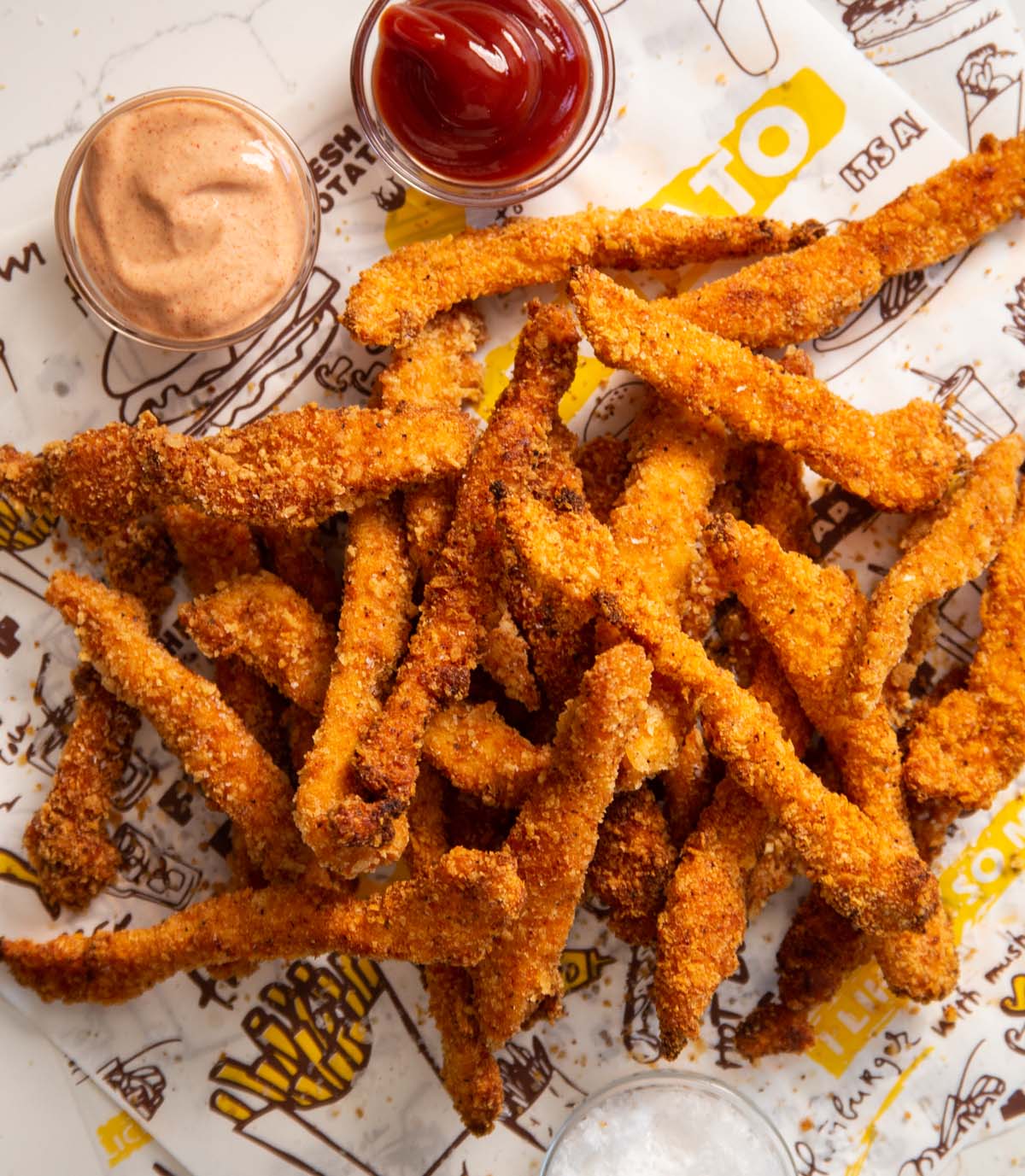 overhead shot of crispy chicken fries stacked on eachother