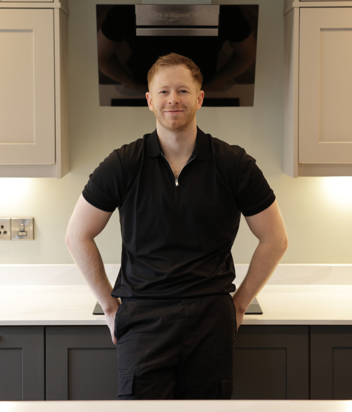chris collins stood wearing all black in kitchen