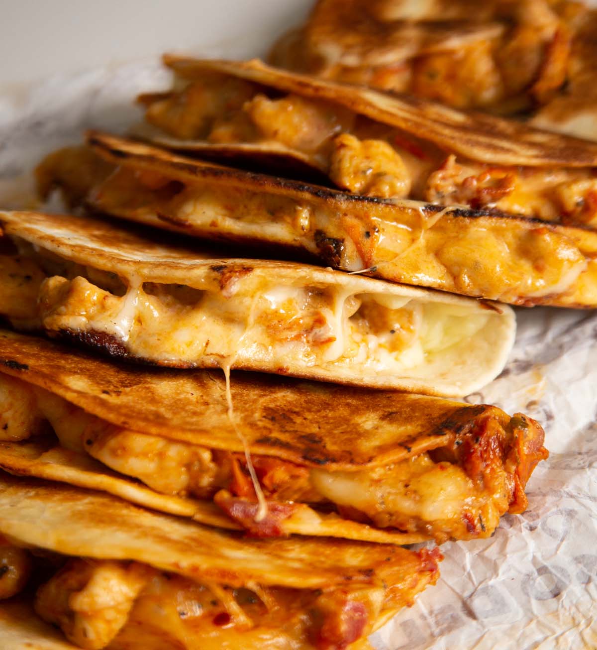 marry me chicken tacos stacked on one another showing cheesy filling