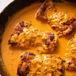 close up shot of creamy paprika chicken in pan
