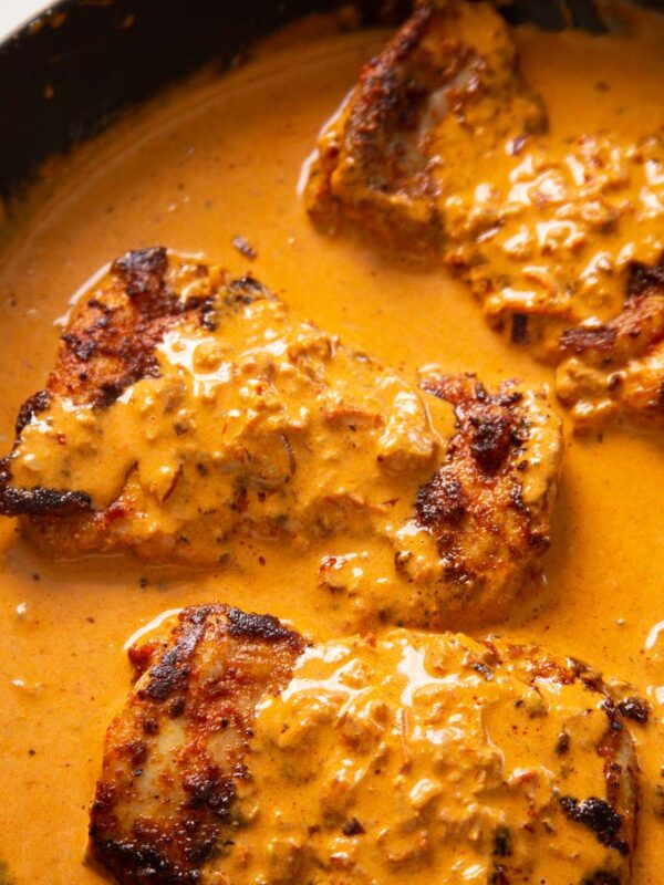 close up shot of creamy paprika chicken in pan