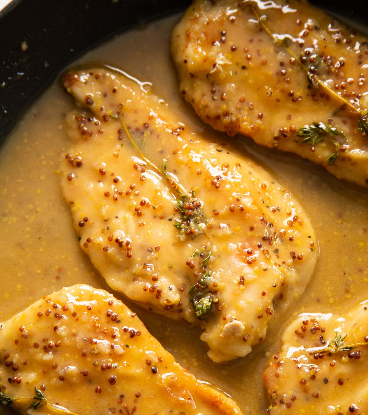 close up overhead shot of honey mustard chicken breast in pan