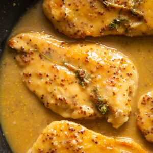 overhead close up shot of honey mustard chicken in pan