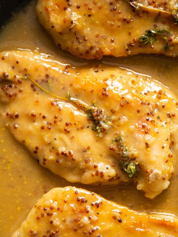 overhead close up shot of honey mustard chicken in pan