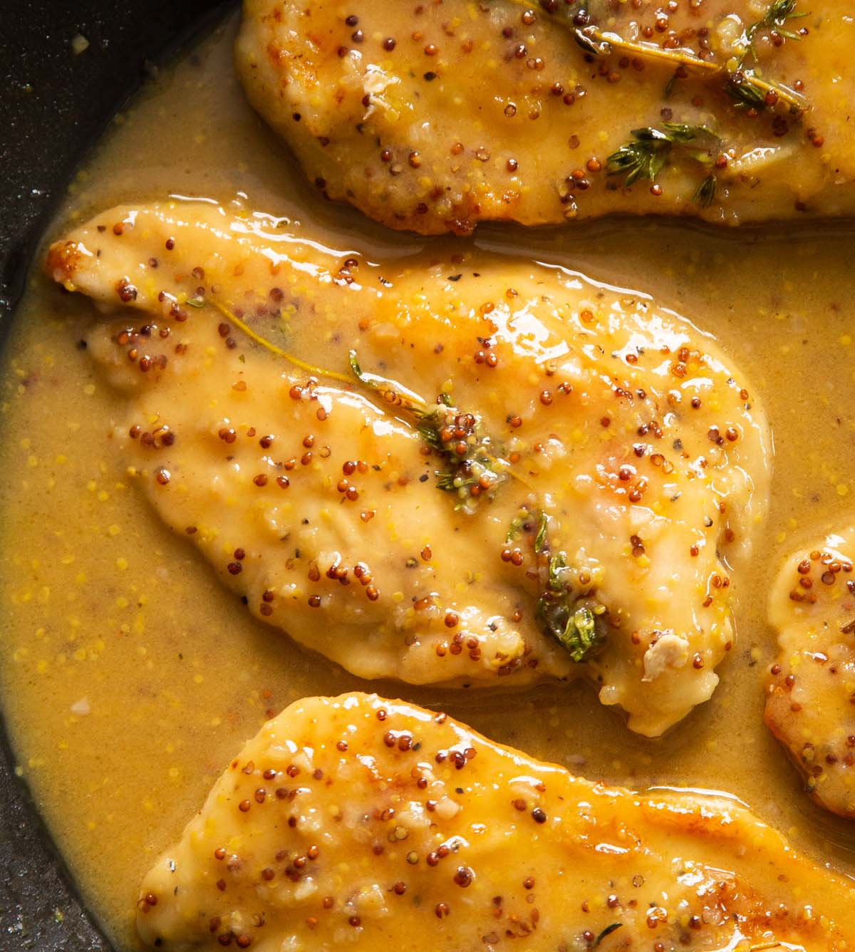 close up overhead shot of honey mustard chicken in pan