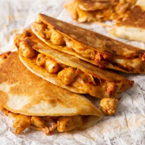 3 marry me chicken tacos stacked on each other showing filling