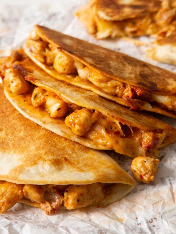 3 marry me chicken tacos stacked on each other showing filling